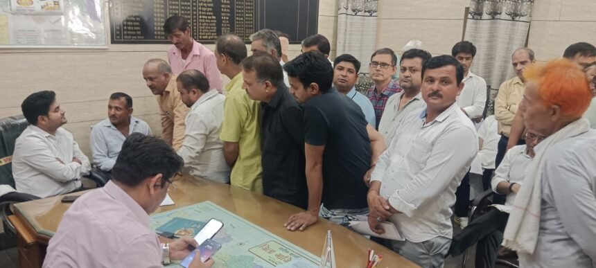 Shopkeepers affected by the construction of a railway overbridge staged a protest at the tehsil office. IMAGE CREDIT TO REPORTER