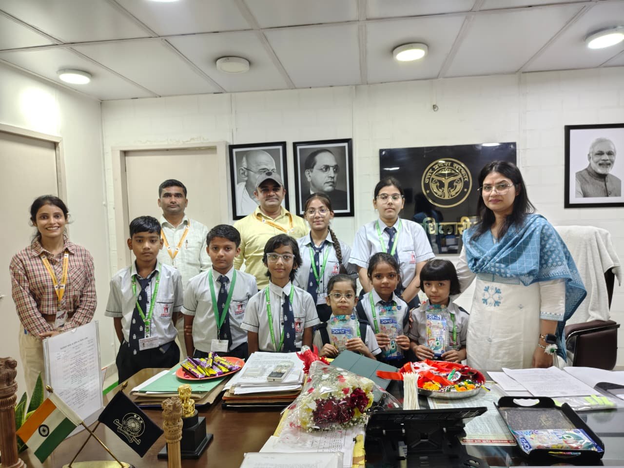 Students of American EduGlobal Academy Tie Rakhi to the District Magistrate — IMAGE CREDIT TO सूचना विभाग